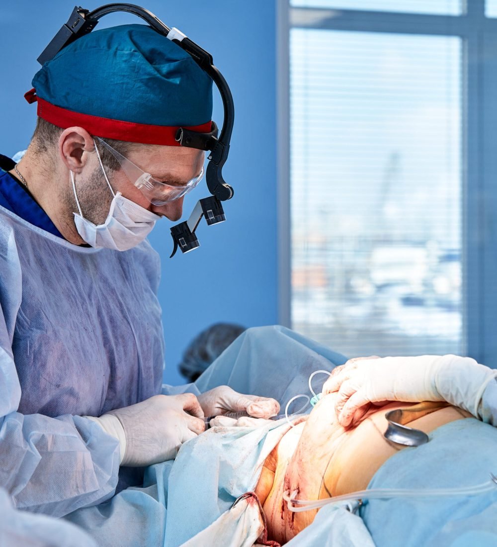 The doctor performs an operation to reconstruct the female breast. Close-up of plastic surgeon performing implantation procedure, breast cancer.