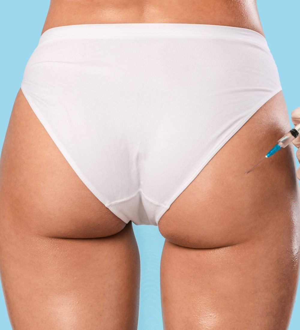 Non-Sugical Butt Lifting Sculptra Concept. Rear back view of young lady getting hip injection at beauty salon, closeup cropped. Surgeon making injection at buttocks area, isolated on studio background